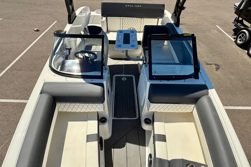 Slide: The Image of 2023 Bayliner DX 2050 boat interior with seating and steering wheel. - 7