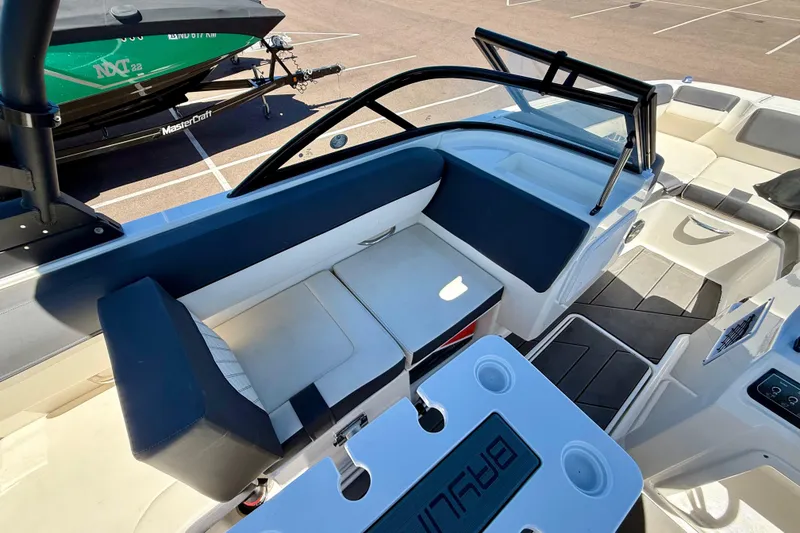 Slide: The Image of 2023 Bayliner DX 2050 boat interior with seating and cup holders. - 9