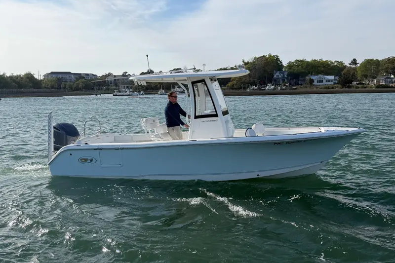 The Image of 2018 Sea Hunt Ultra 235 SE boat cruising on a calm waterway. - 1