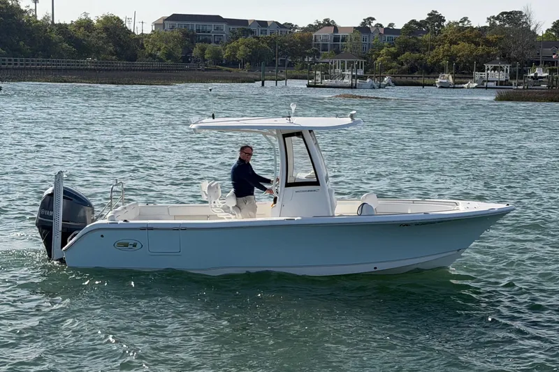 Slide: The Image of 2018 Sea Hunt Ultra 235 SE boat cruising on a scenic waterway. - 10