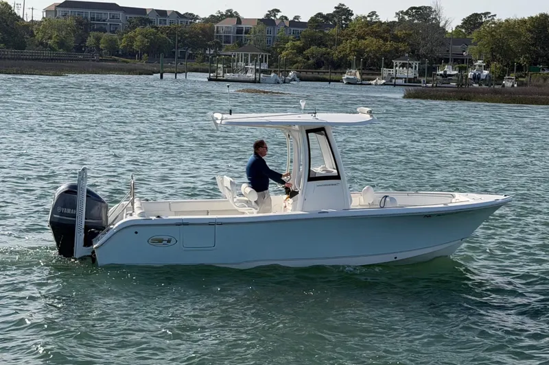 Slide: The Image of 2018 Sea Hunt Ultra 235 SE boat cruising on a calm waterway. - 11
