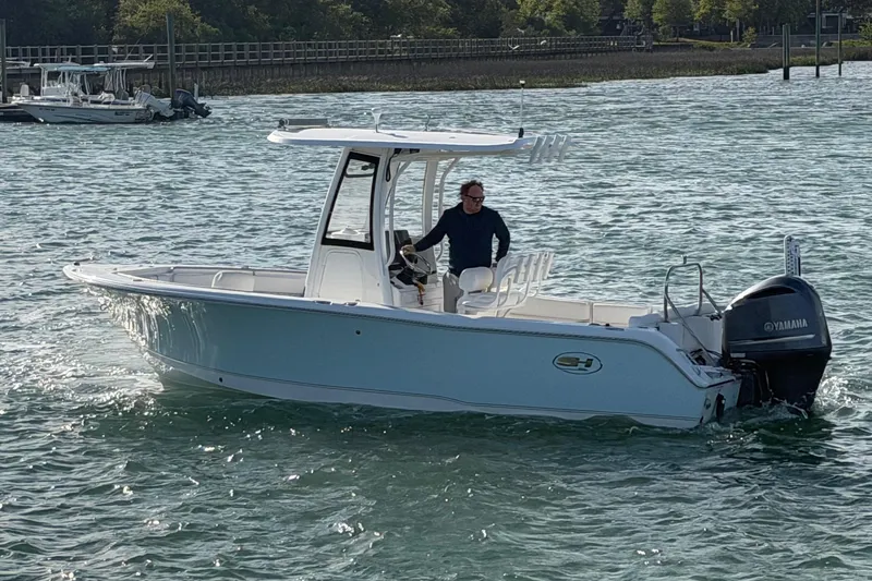 Slide: The Image of 2018 Sea Hunt Ultra 235 SE boat cruising on water with Yamaha outboard motor. - 13