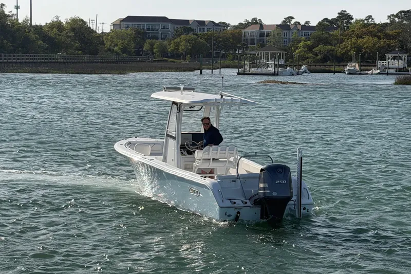 Slide: The Image of 2018 Sea Hunt Ultra 235 SE boat cruising on a scenic waterway. - 14