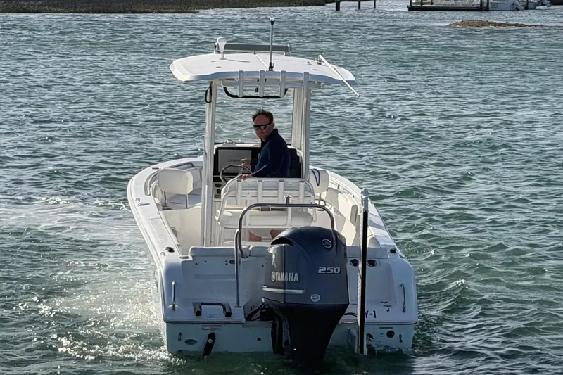 Slide: The Image of 2018 Sea Hunt Ultra 235 SE boat cruising on open water. - 15