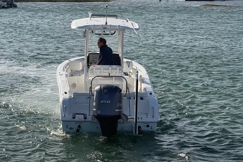Slide: The Image of 2018 Sea Hunt Ultra 235 SE boat navigating on open water. - 16