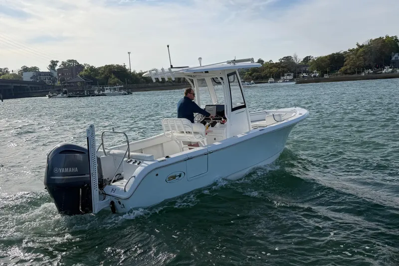 Slide: The Image of 2018 Sea Hunt Ultra 235 SE boat cruising on water with Yamaha engine. - 19