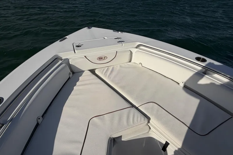Slide: The Image of Bow seating area of 2018 Sea Hunt Ultra 235 SE boat on water. - 24