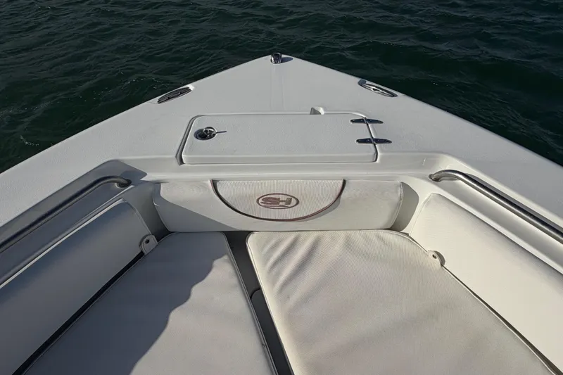 Slide: The Image of Bow seating area of a 2018 Sea Hunt Ultra 235 SE boat on the water. - 26