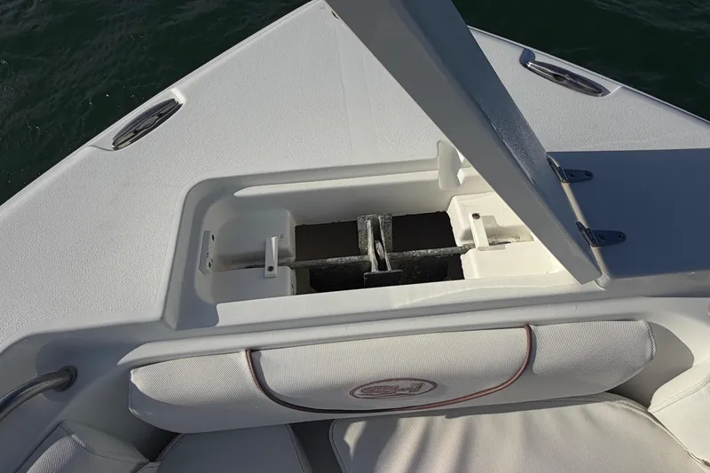 Slide: The Image of 2018 Sea Hunt Ultra 235 SE boat interior, featuring seating and storage compartments. - 27