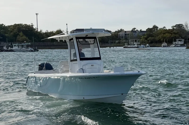 Slide: The Image of 2018 Sea Hunt Ultra 235 SE boat cruising on a calm waterway. - 3