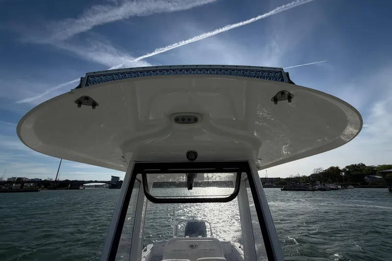 Slide: The Image of 2018 Sea Hunt Ultra 235 SE boat on water under clear blue sky. - 30