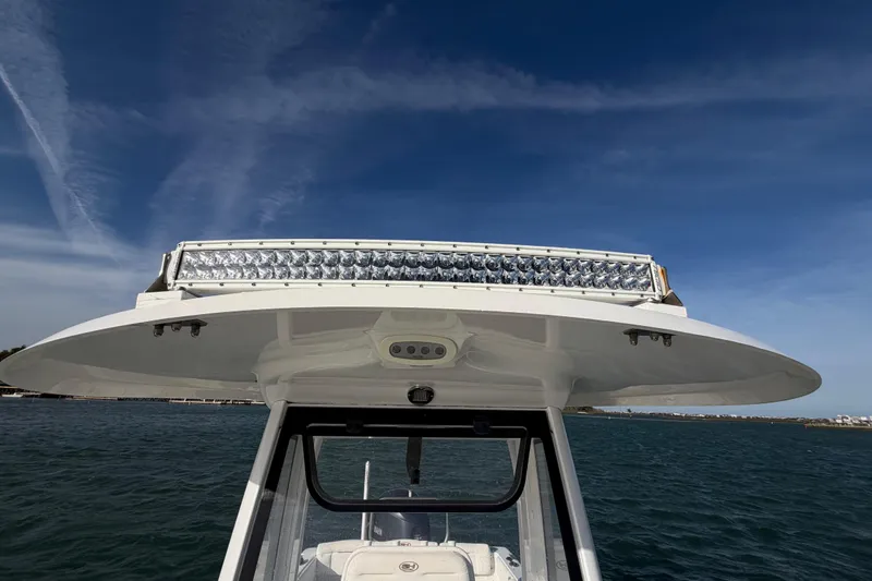 Slide: The Image of 2018 Sea Hunt Ultra 235 SE boat with LED light bar, under clear blue sky. - 33