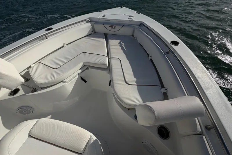 Slide: The Image of 2018 Sea Hunt Ultra 235 SE boat interior with white cushioned seating. - 34