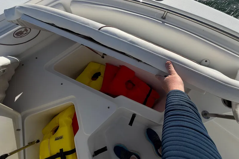 Slide: The Image of 2018 Sea Hunt Ultra 235 SE boat storage with life jackets and seating. - 37
