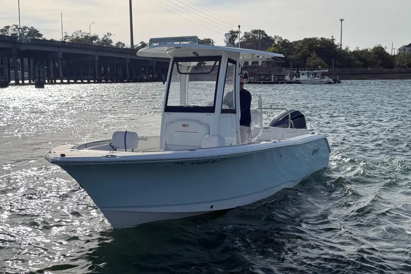 Slide: The Image of 2018 Sea Hunt Ultra 235 SE boat cruising on a sunny day near a bridge. - 4