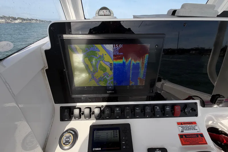 Slide: The Image of Dashboard of a 2018 Sea Hunt Ultra 235 SE boat with navigation display. - 41