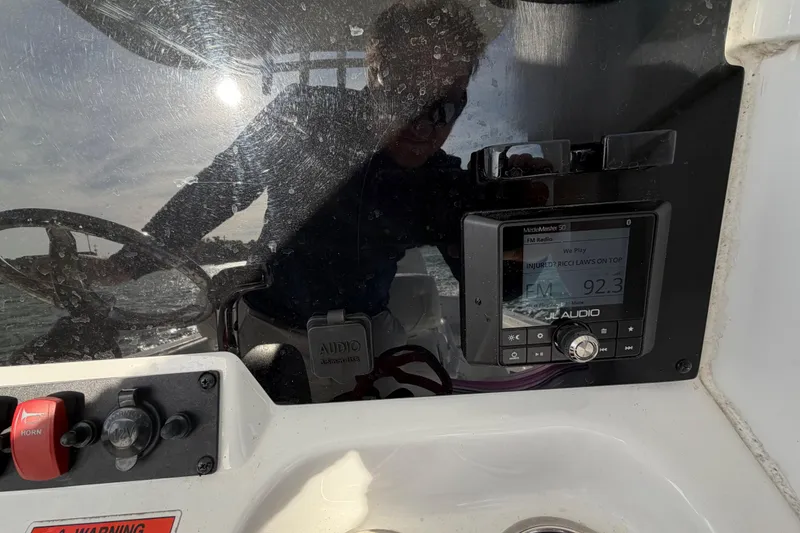Slide: The Image of 2018 Sea Hunt Ultra 235 SE dashboard with radio display and steering wheel. - 43