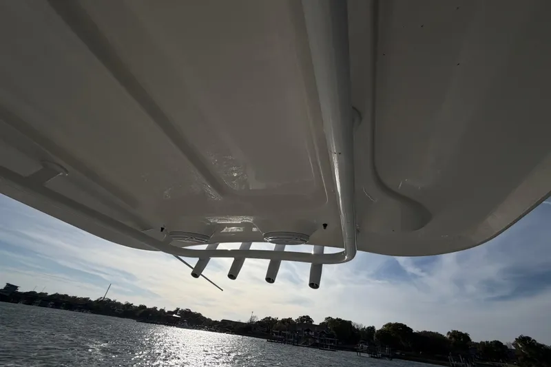 Slide: The Image of 2018 Sea Hunt Ultra 235 SE boat underside view on water, sunny day. - 48