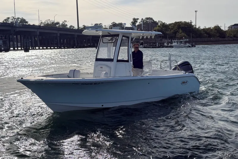 Slide: The Image of 2018 Sea Hunt Ultra 235 SE boat cruising on a sunny day near a bridge. - 5