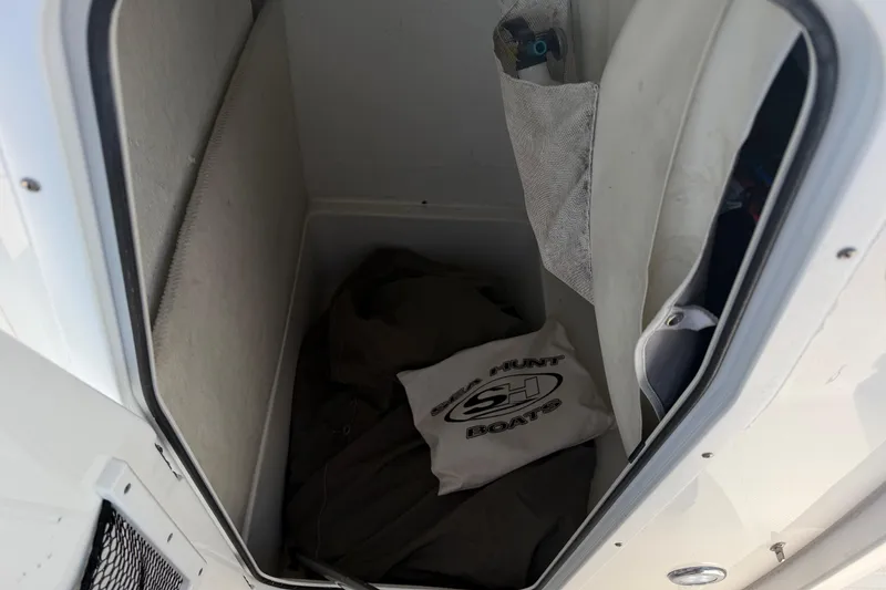 Slide: The Image of Storage compartment in a 2018 Sea Hunt Ultra 235 SE boat with branded cover. - 53