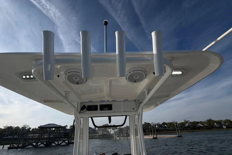 Slide: The Image of 2018 Sea Hunt Ultra 235 SE boat with T-top and rod holders on a sunny day. - 57