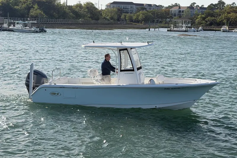 Slide: The Image of 2018 Sea Hunt Ultra 235 SE boat cruising on a calm waterway. - 9