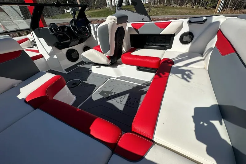 Slide: The Image of 2024 Axis A20 boat interior with red and white seating, modern dashboard, and spacious layout. - 10