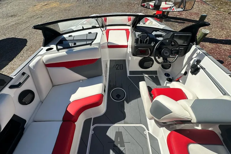 Slide: The Image of 2024 Axis A20 boat interior with red and white seating, modern dashboard, and sleek design. - 12