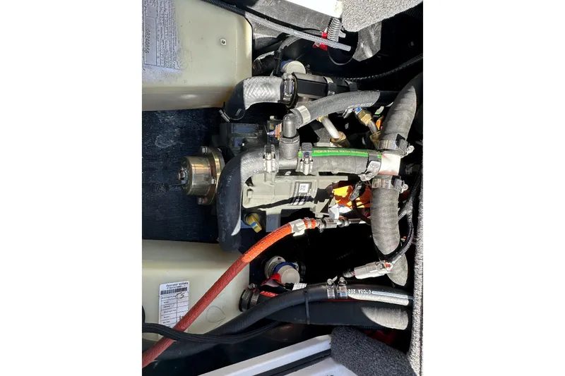 Slide: The Image of 2024 Axis A20 engine compartment with visible hoses and components. - 19