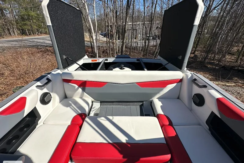 Slide: The Image of 2024 Axis A20 boat interior with red and white seating, open storage compartments. - 21