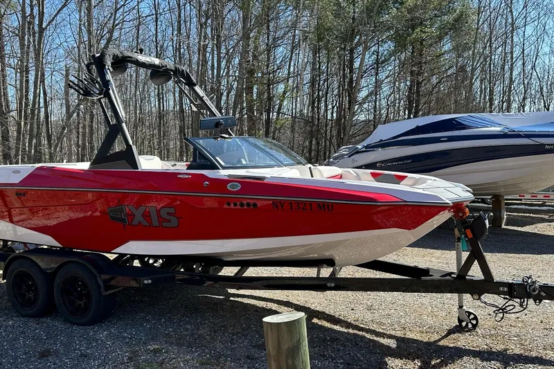 Slide: The Image of 2024 Axis A20 boat in vibrant red on a trailer, parked outdoors. - 5