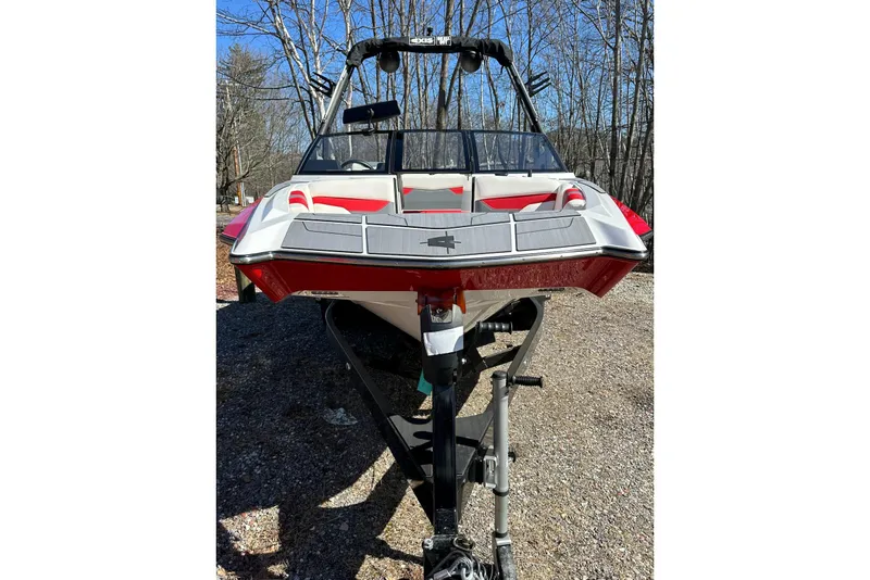 Slide: The Image of 2024 Axis A20 boat on trailer, red and white design, parked outdoors. - 6