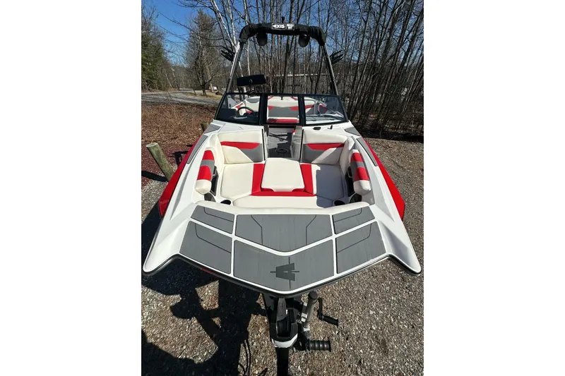 Slide: The Image of 2024 Axis A20 boat with red and white interior, parked outdoors. - 7