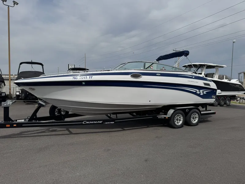 The Image of 2003 Crownline 270 BR boat on trailer outdoors. - 1