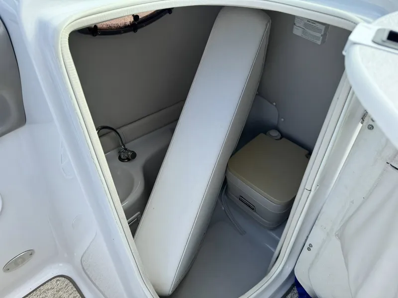 Slide: The Image of Interior of 2003 Crownline 270 BR with toilet and sink. - 12