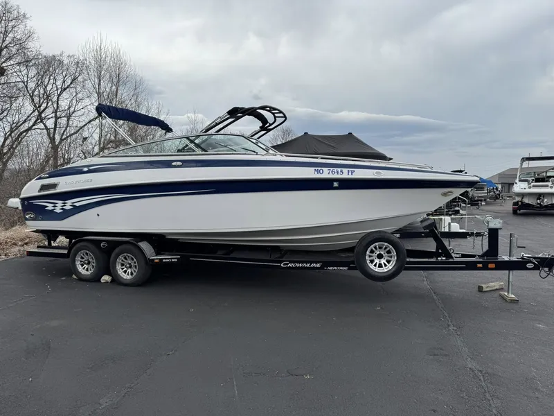 Slide: The Image of 2003 Crownline 270 BR boat parked on trailer outdoors. - 14