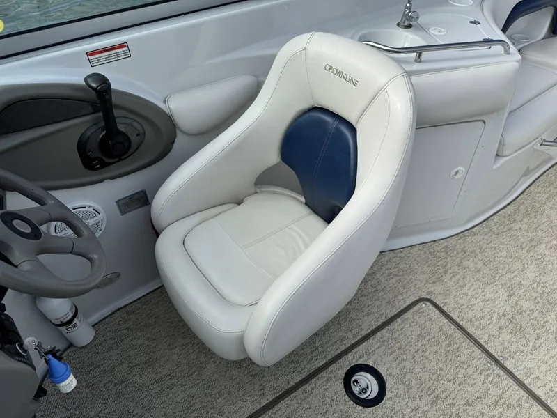 Slide: The Image of Interior of a 2003 Crownline 270 BR boat with helm seat. - 15