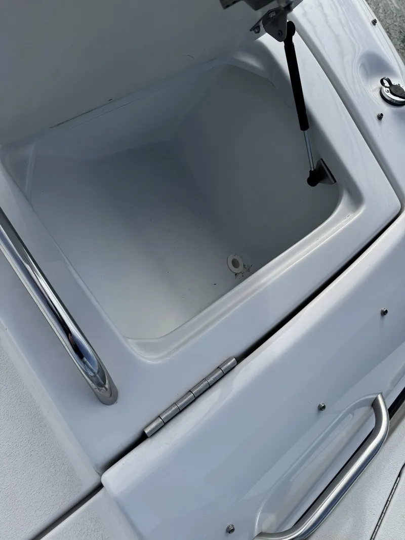 Slide: The Image of Open storage compartment on a 2003 Crownline 270 BR boat. - 17