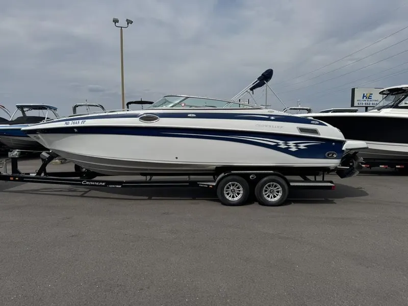 Slide: The Image of 2003 Crownline 270 BR boat on trailer outdoors. - 22