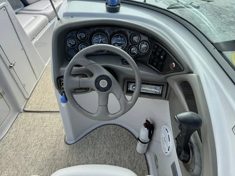 Slide: The Image of Steering console of a 2003 Crownline 270 BR boat. - 23