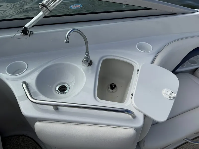 Slide: The Image of Crownline 270 BR 2003 boat kitchenette with sink and storage. - 7