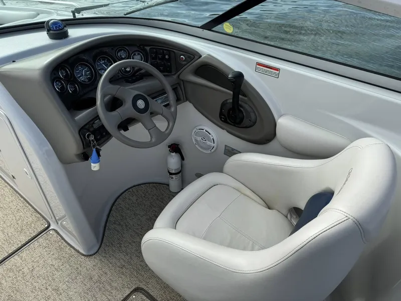 Slide: The Image of Helm of a 2003 Crownline 270 BR boat with steering wheel and gauges. - 8