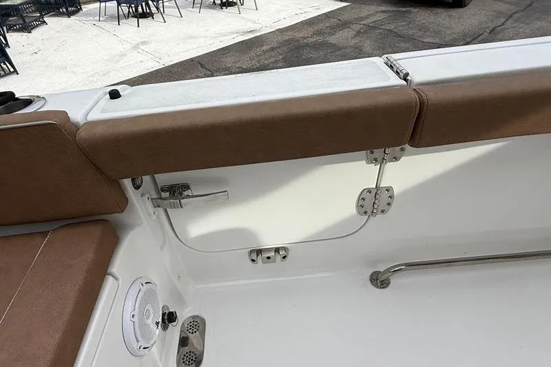 Slide: The Image of Interior view of 2023 Sea Hunt Ultra 255 SE boat with brown seating and stainless steel fittings. - 13