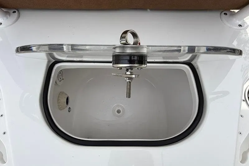 Slide: The Image of 2023 Sea Hunt Ultra 255 SE livewell with open lid and drain plug. - 14