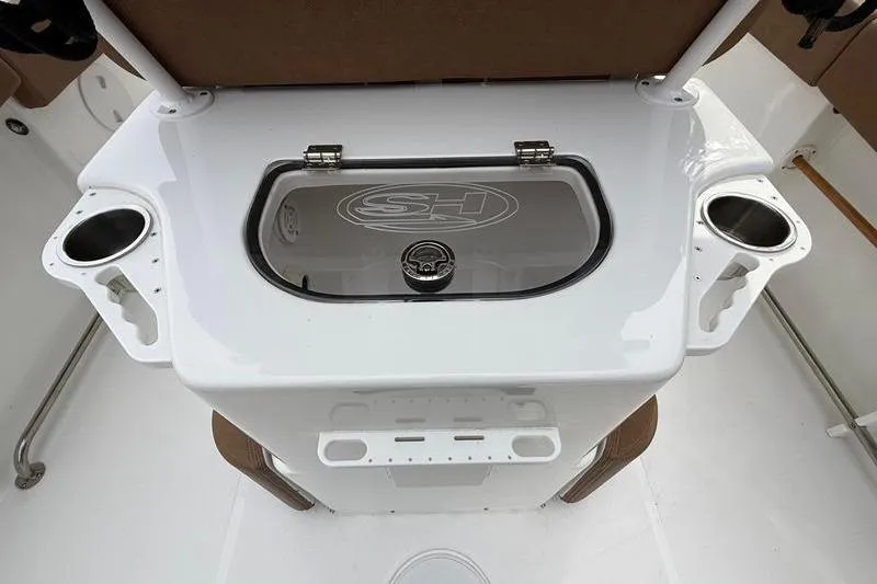 Slide: The Image of 2023 Sea Hunt Ultra 255 SE boat console with cup holders and storage compartment. - 15
