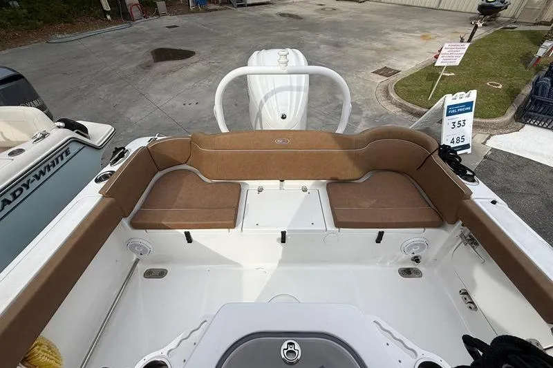 Slide: The Image of 2023 Sea Hunt Ultra 255 SE boat interior with brown seating and white deck. - 16