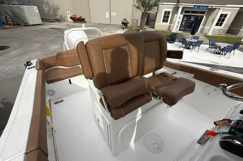 Slide: The Image of 2023 Sea Hunt Ultra 255 SE boat interior with brown seating and modern design. - 18