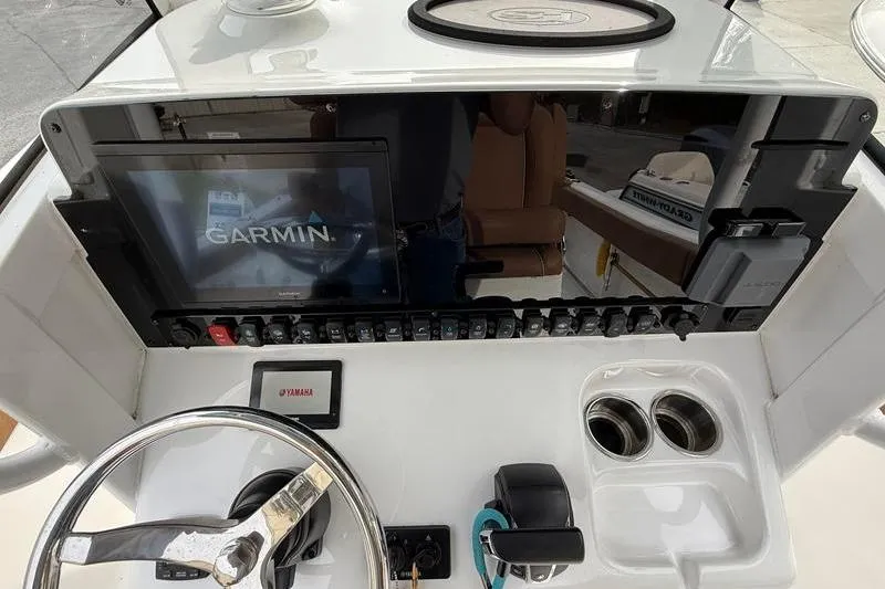 Slide: The Image of 2023 Sea Hunt Ultra 255 SE dashboard with Garmin display and Yamaha controls. - 19