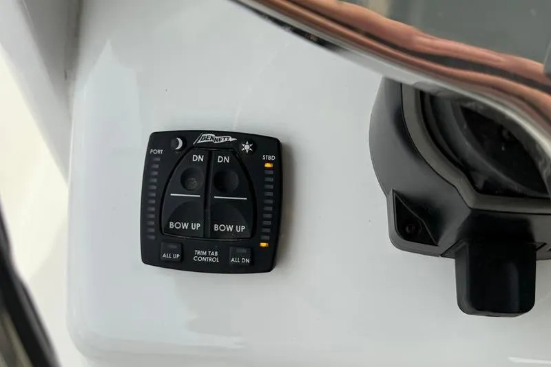 Slide: The Image of Trim tab control panel on 2023 Sea Hunt Ultra 255 SE boat dashboard. - 20