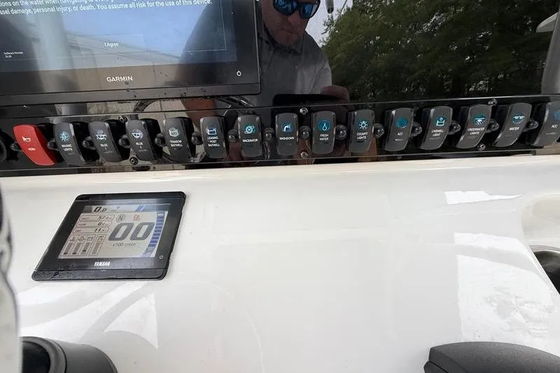 Slide: The Image of Control panel of 2023 Sea Hunt Ultra 255 SE boat with Garmin display and Yamaha screen. - 21